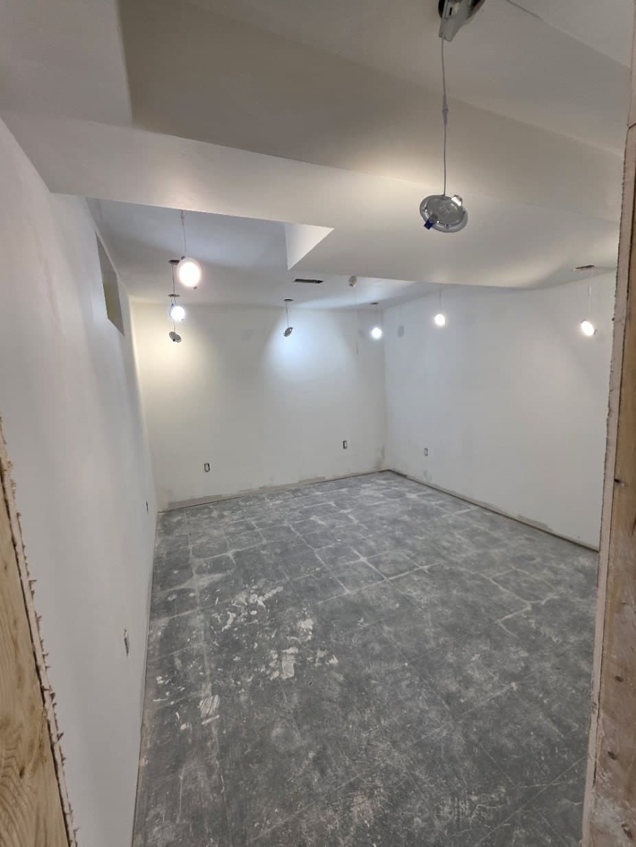 Oshawa basement during construction: drywall hung with pot lights, before finishing