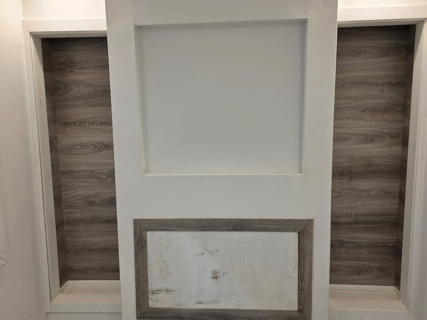 Media-wall built-in with wood-look side panels in the finished basement